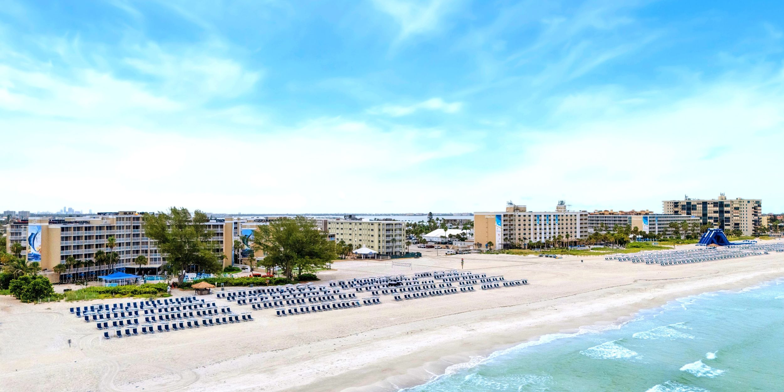 A Beach With Buildings In The Background