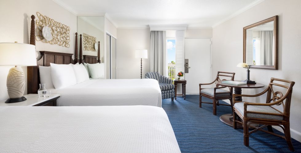 A Hotel Room With A Bed And Chairs