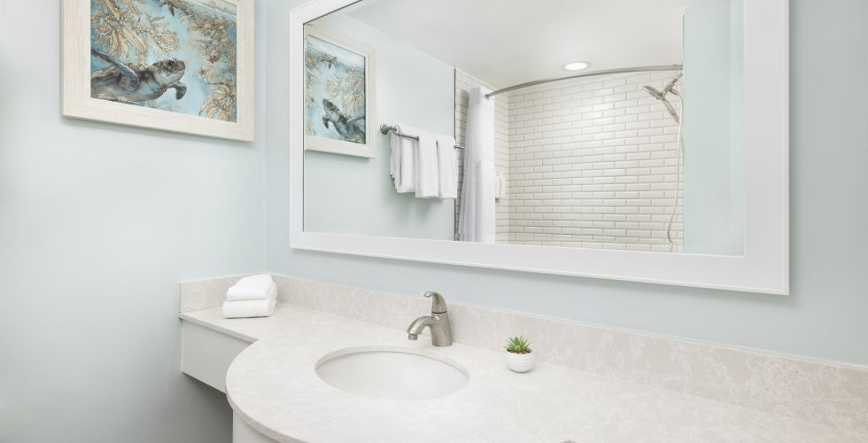 A Bathroom With A Large Mirror