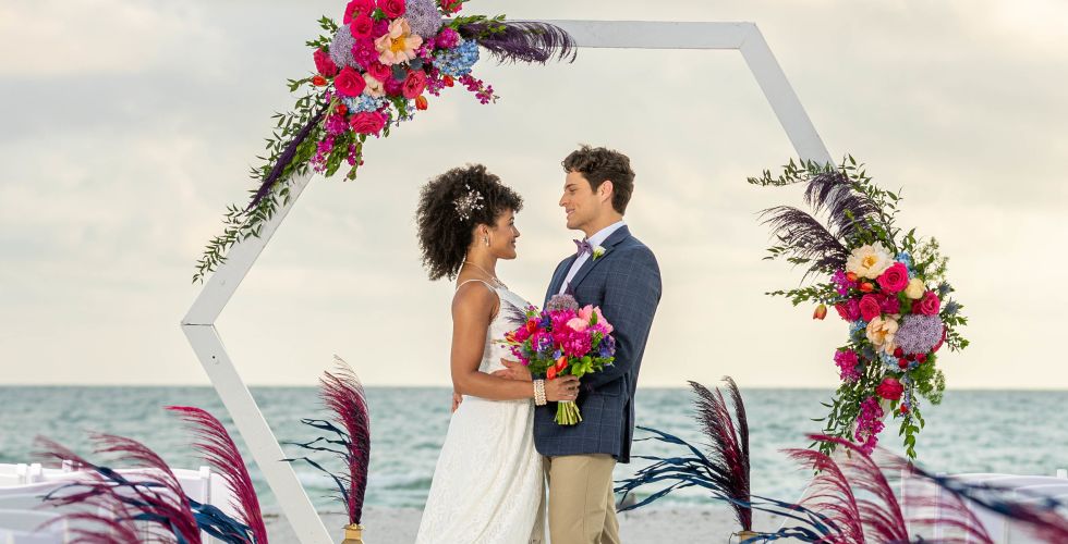 A Man And Woman Holding Flowers