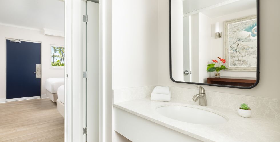 A Bathroom With A Large Mirror
