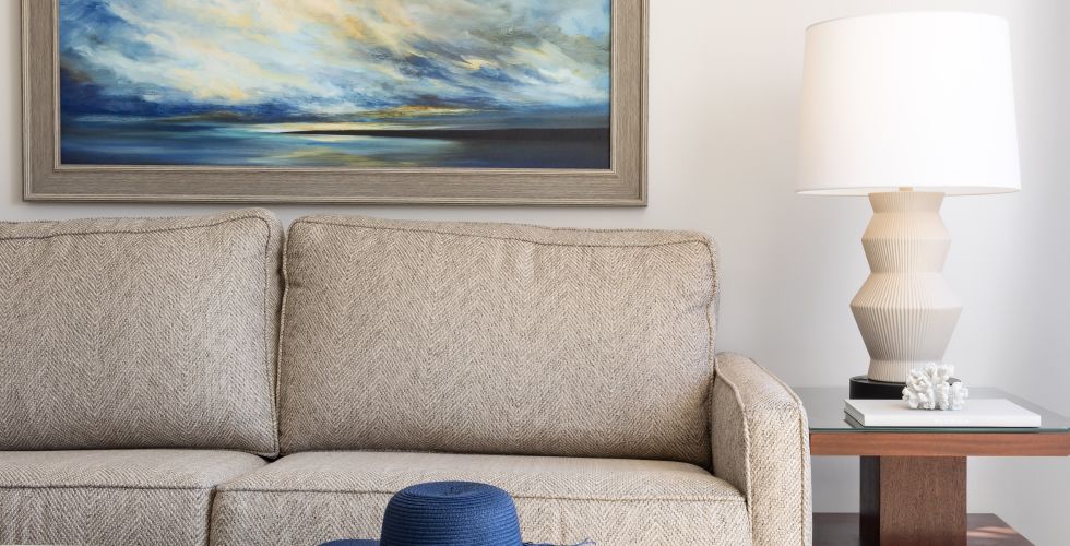 A Living Room With A Couch And A Lamp