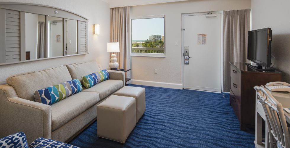 A Living Room Filled With Furniture And A Large Window