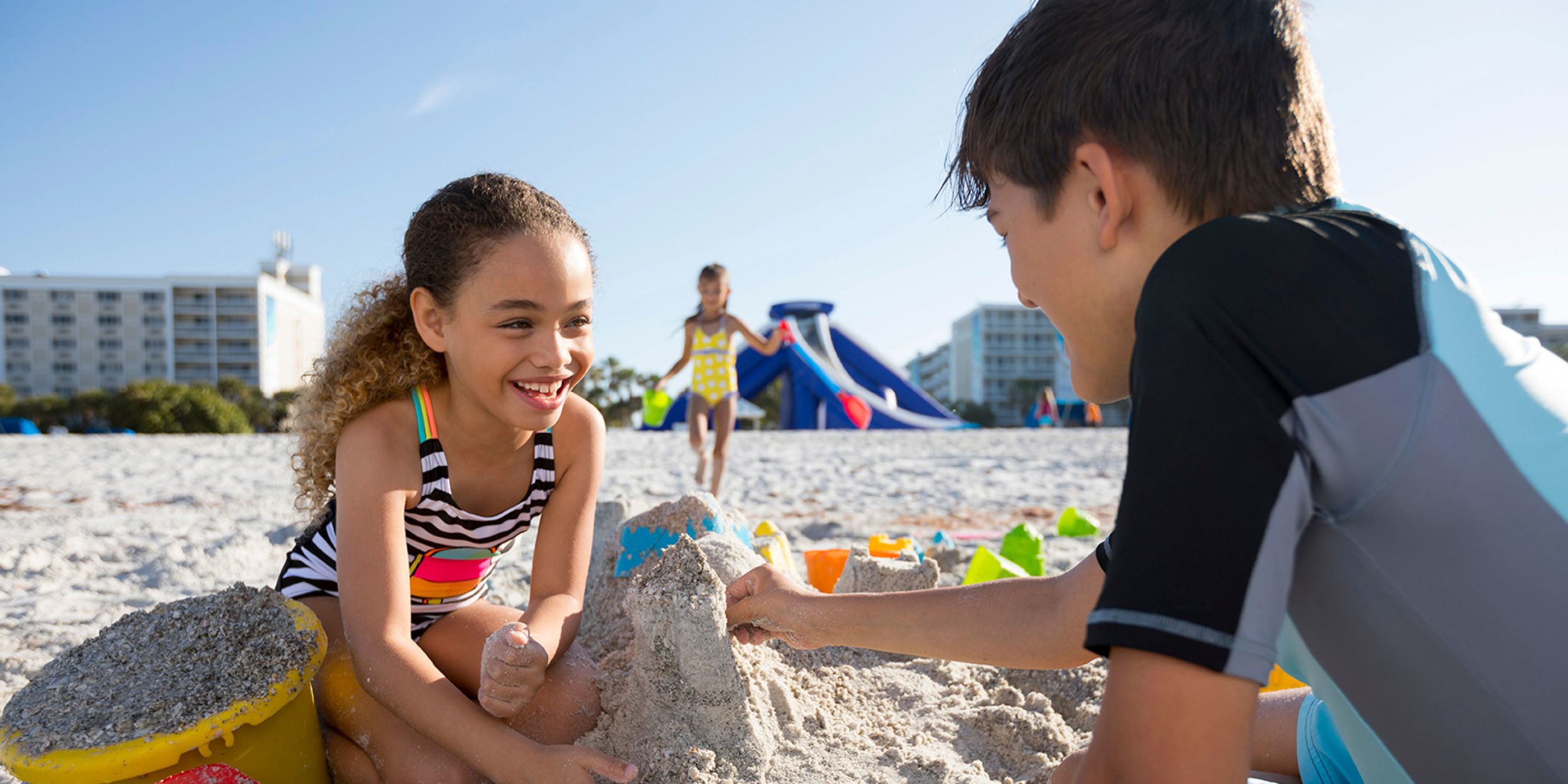A Young Boy Sitting At A Beach