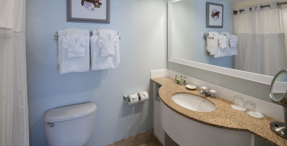 A Room With A Sink And A Mirror