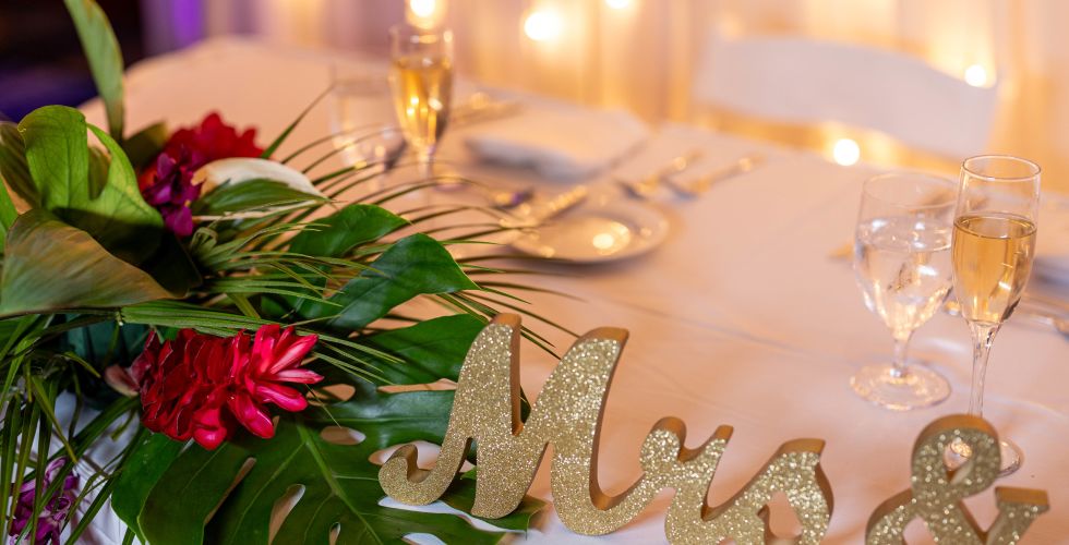 A Table With Glasses And Flowers
