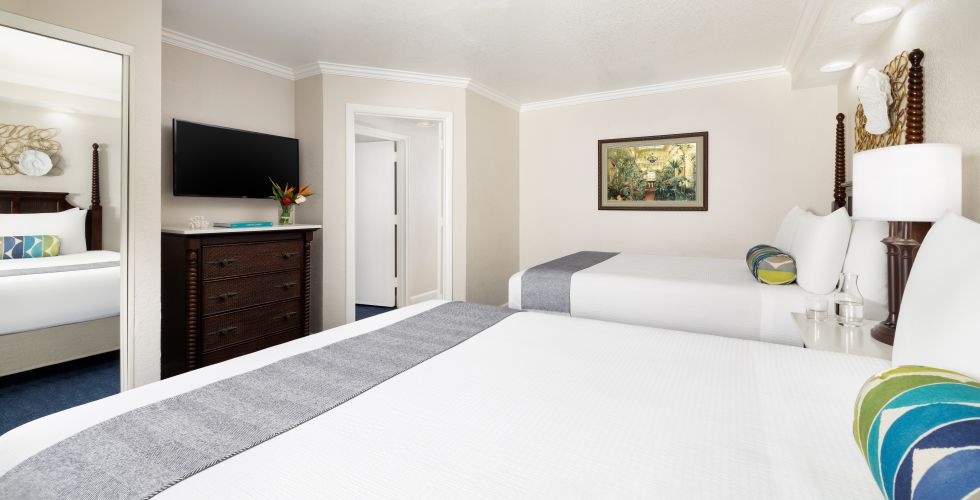 A Bedroom With A Bed And A Television