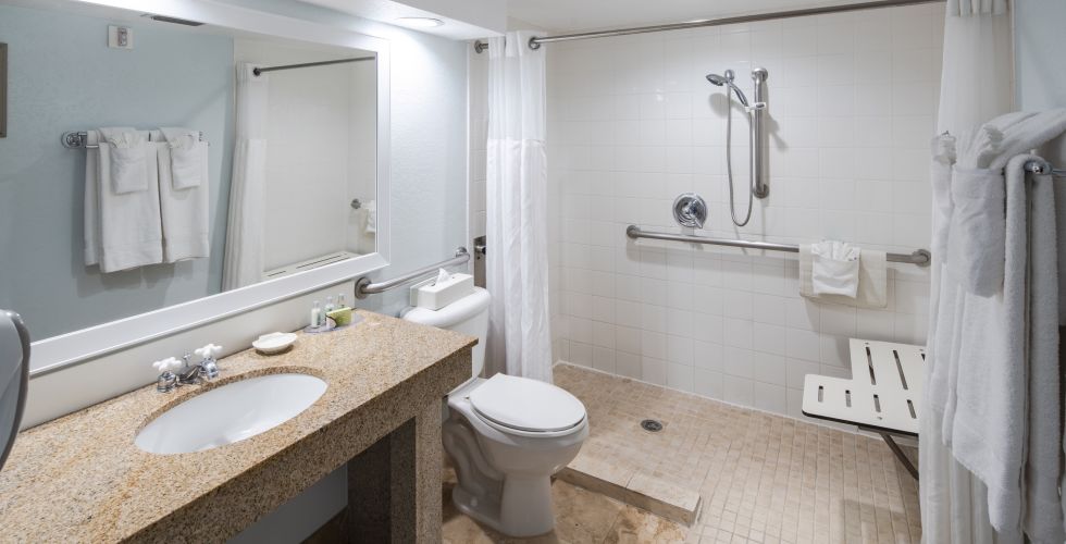 A Room With A Sink And A Mirror