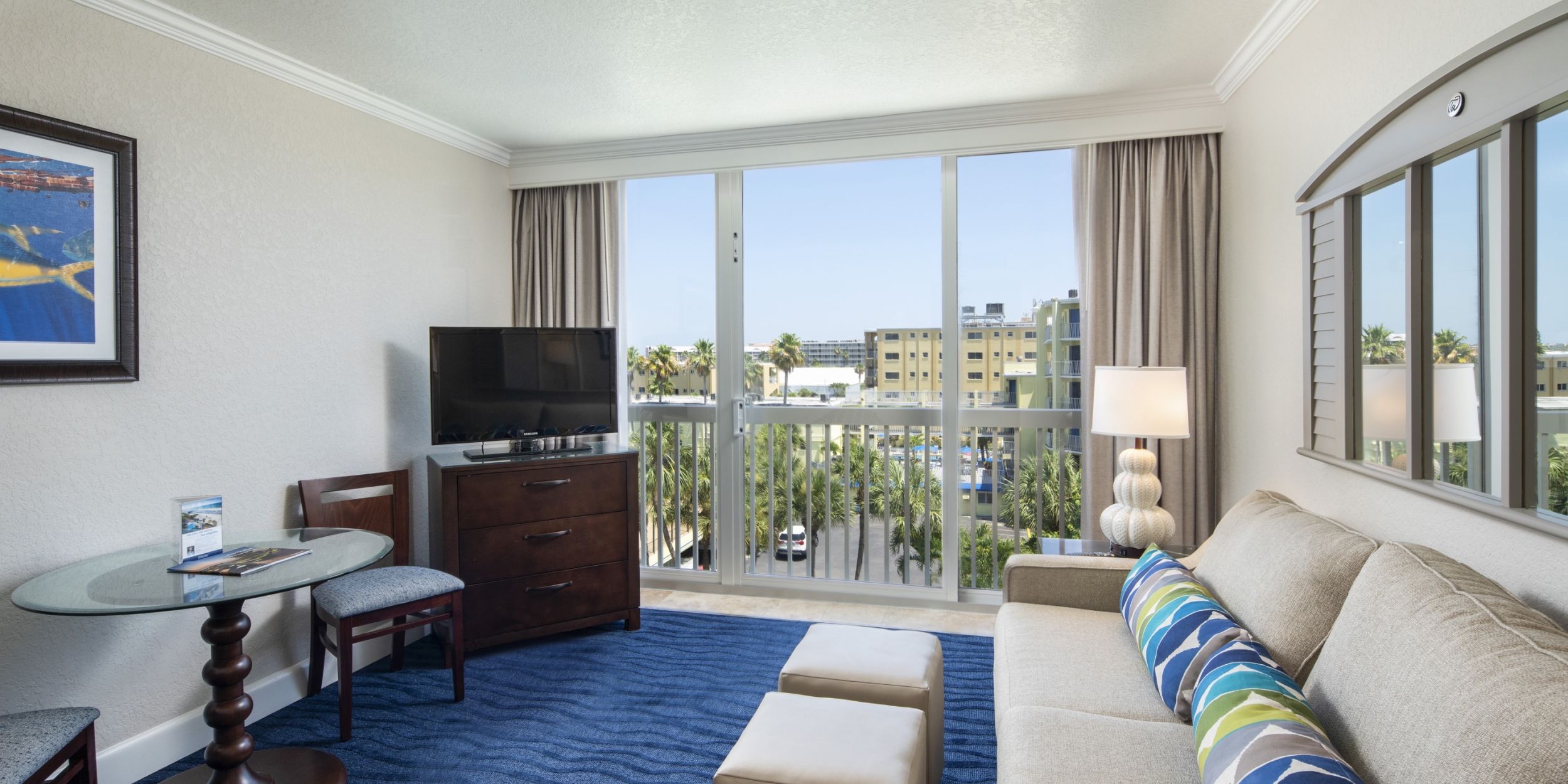 A Living Room Filled With Furniture And A Large Window