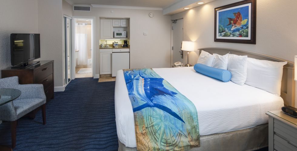 A Bedroom With A Bed And Desk In A Room