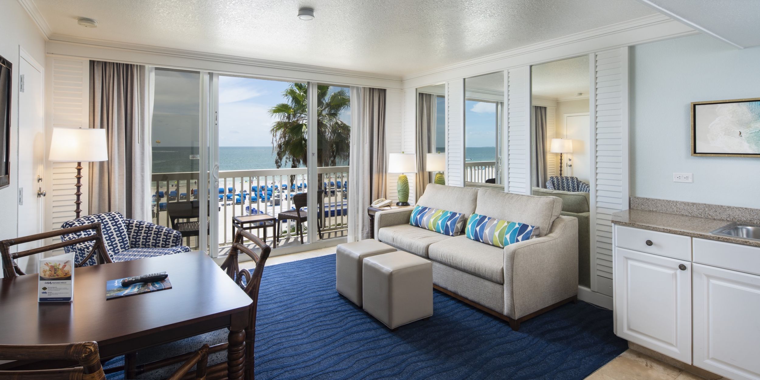A Living Room Filled With Furniture And A Large Window