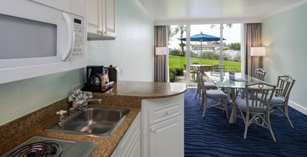 A Kitchen With A Stove Top Oven Sitting Next To A Window