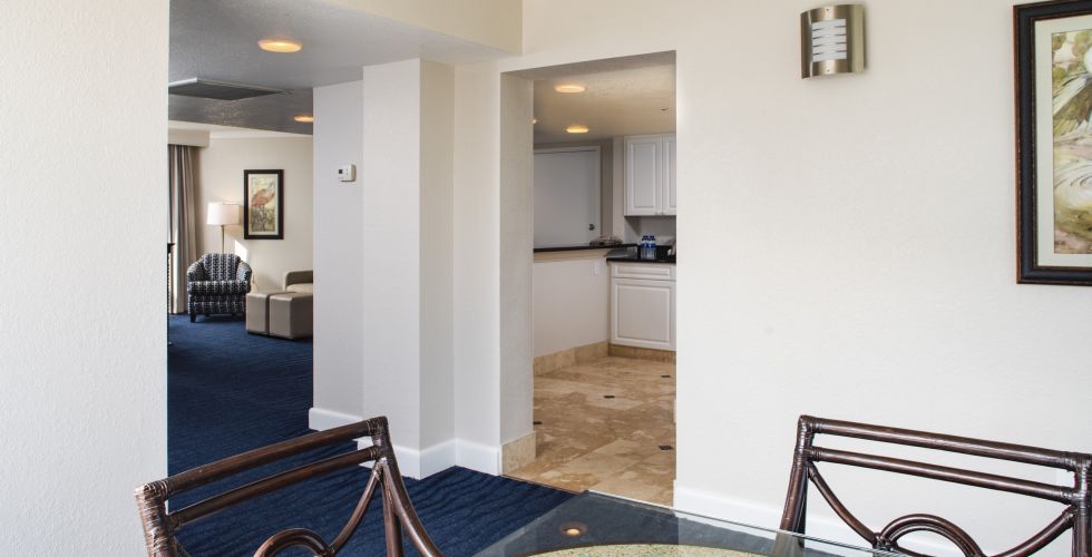 A Bedroom With A Bed And A Chair In A Room