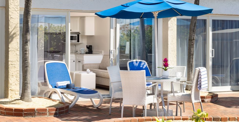 A Patio With Chairs And Umbrella