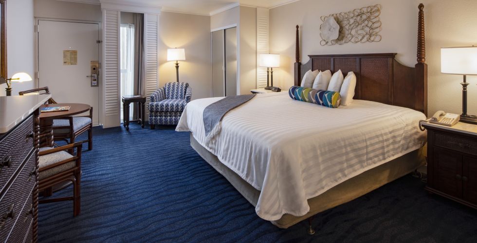 A Bedroom With A Large Bed In A Hotel Room