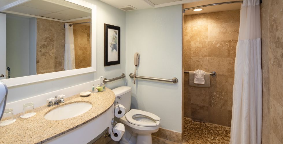 A Room With A Sink And A Mirror