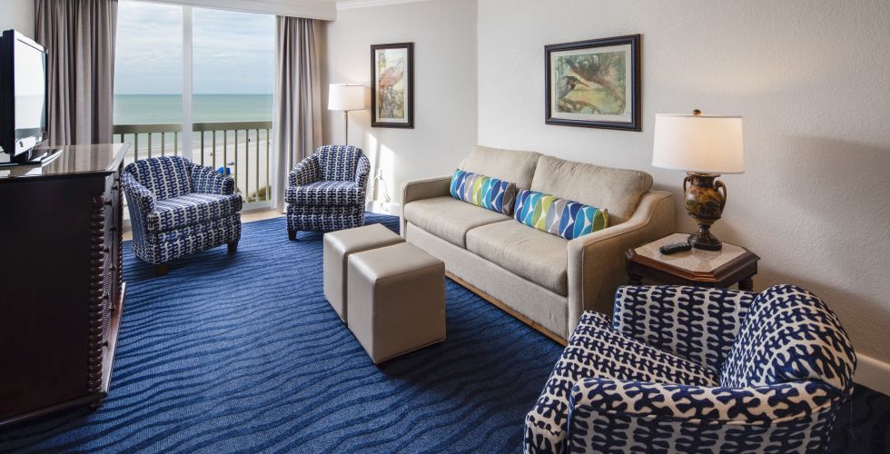 A Living Room With A Bed And Chair