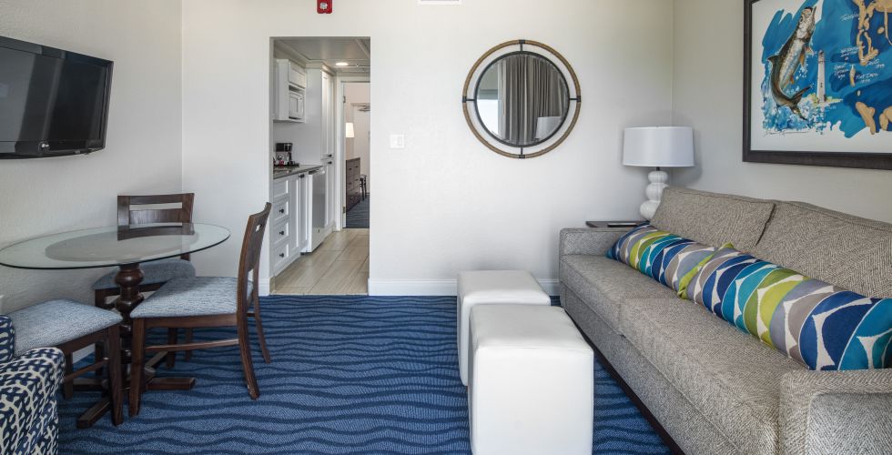 A Bedroom With A Bed And A Mirror