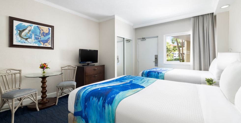 A Bedroom With A Bed And A Tv