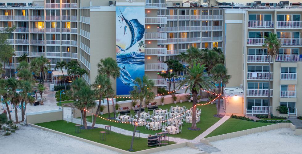 A Beach With Palm Trees And Buildings