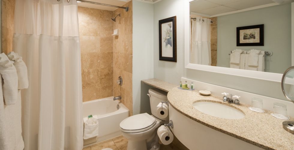 A Hotel Room With A Sink And A Mirror