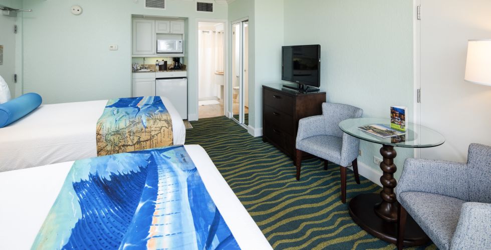 A Bedroom With A Bed And A Chair In A Room