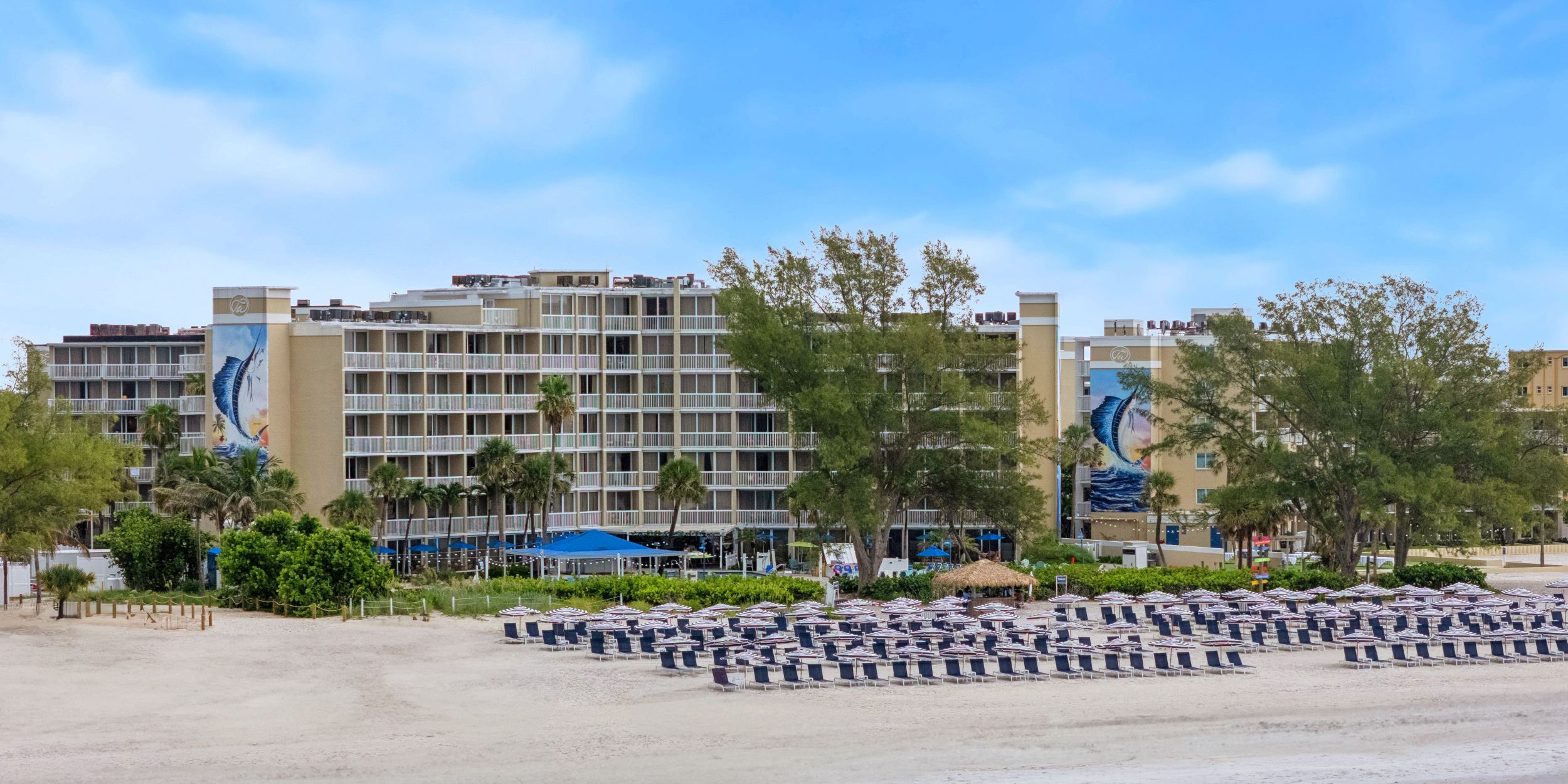 A Beach With Buildings And Trees