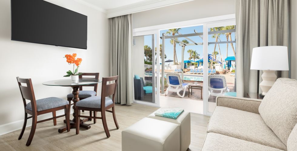 A Living Room With A Table And Chairs