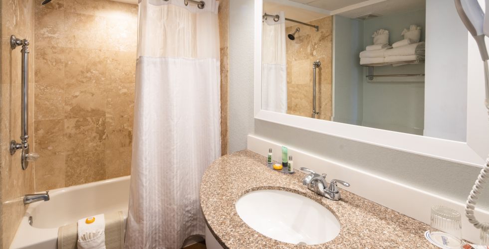 A Bathroom With A Large Mirror