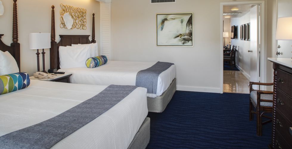 A Bedroom With A Bed And A Chair In A Room