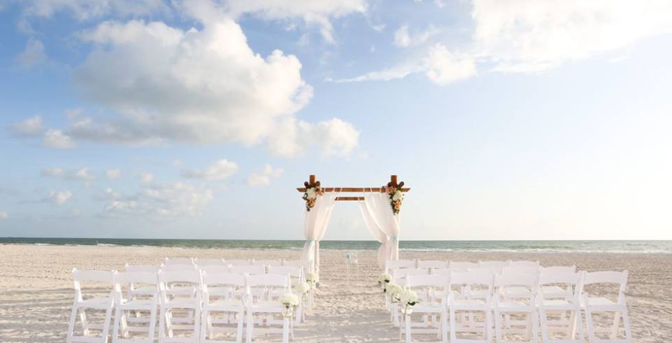 A Group Of White Chairs On A Beach
