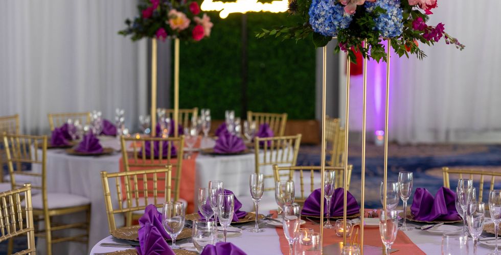 A Dining Table With Purple Flowers