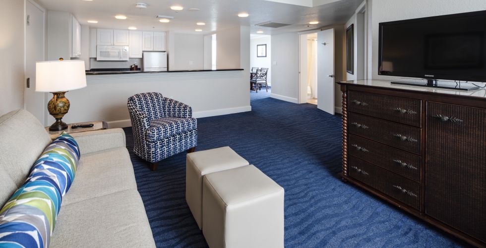 A Living Room Filled With Furniture And A Flat Screen Tv